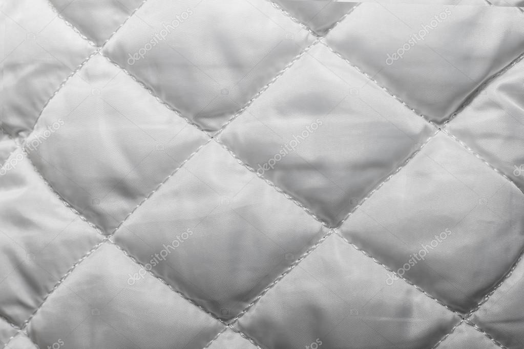 Quilted fabric texture of white color for hammering, Stock Photo